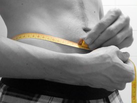 Man Measuring His Waist With a Tape Measure (CC)
